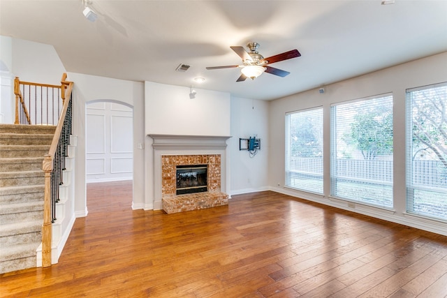 unfurnished living room with wood-type flooring and ceiling fan