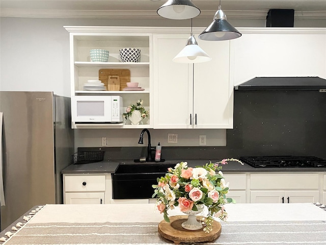 kitchen with white cabinets, stainless steel fridge, and gas stovetop