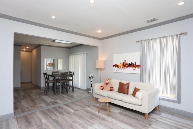 living room featuring wood-type flooring and crown molding