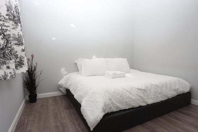 bedroom with dark hardwood / wood-style floors