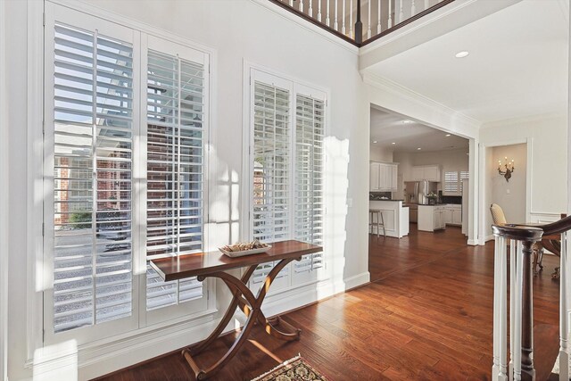 interior space with crown molding and dark hardwood / wood-style flooring