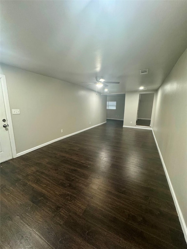 empty room with dark wood-type flooring and ceiling fan