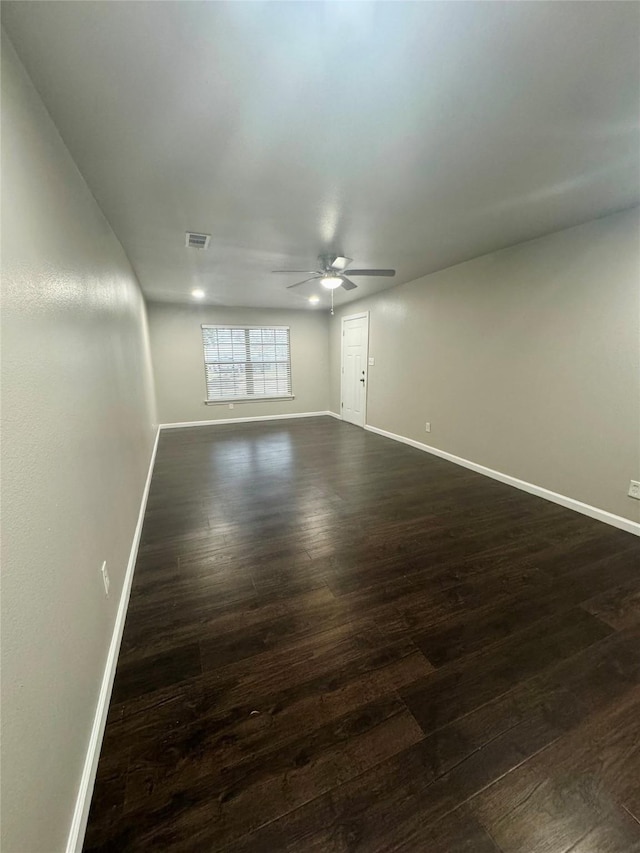 unfurnished room with dark hardwood / wood-style floors and ceiling fan