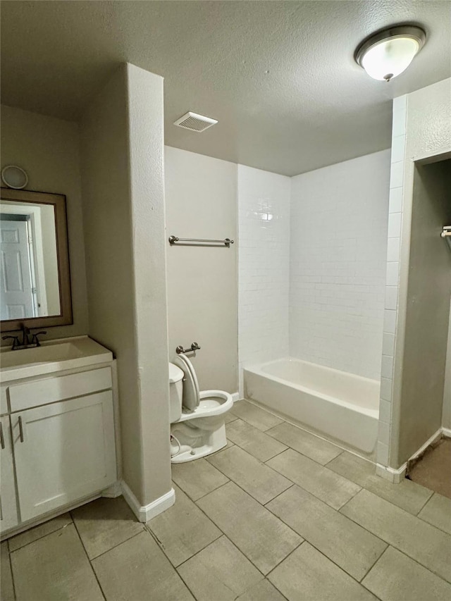 full bathroom featuring toilet, a textured ceiling, shower / tub combination, vanity, and tile patterned flooring