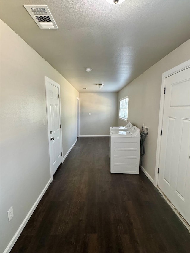 laundry room featuring washer hookup, dark wood-type flooring, and a textured ceiling