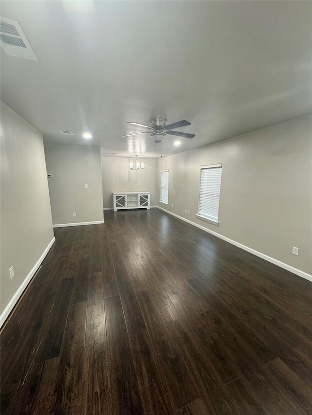 unfurnished living room featuring dark wood-type flooring and ceiling fan