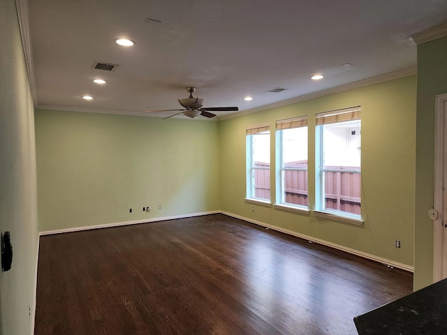 empty room with dark wood-type flooring, ceiling fan, and crown molding