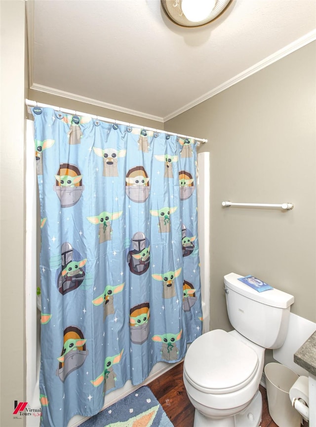 bathroom featuring toilet, wood-type flooring, ornamental molding, and walk in shower