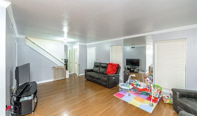 living room featuring hardwood / wood-style flooring and crown molding