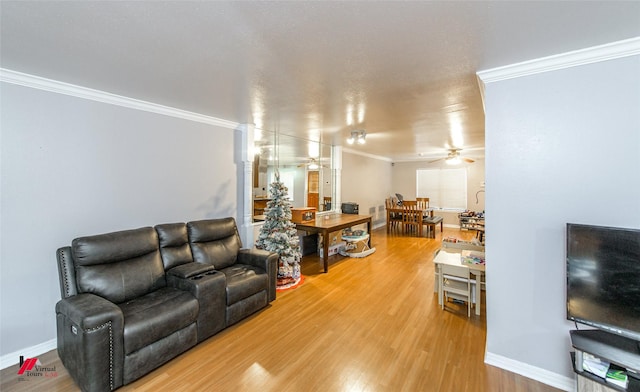 living room featuring hardwood / wood-style flooring, crown molding, and ceiling fan