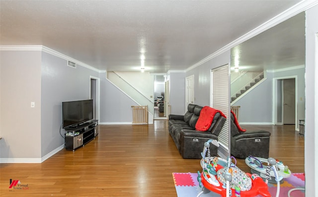 living room featuring ornamental molding and wood-type flooring