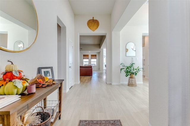 hallway featuring light wood-type flooring and french doors