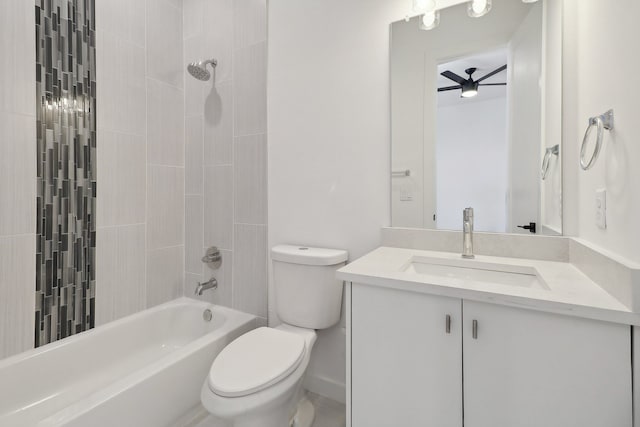 full bathroom featuring ceiling fan, vanity, toilet, and tiled shower / bath combo