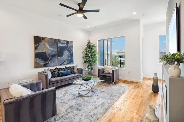 living room featuring light hardwood / wood-style floors and ceiling fan