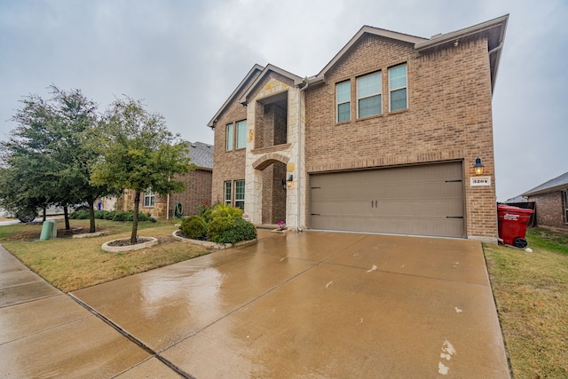 view of front of house featuring a garage and a front lawn