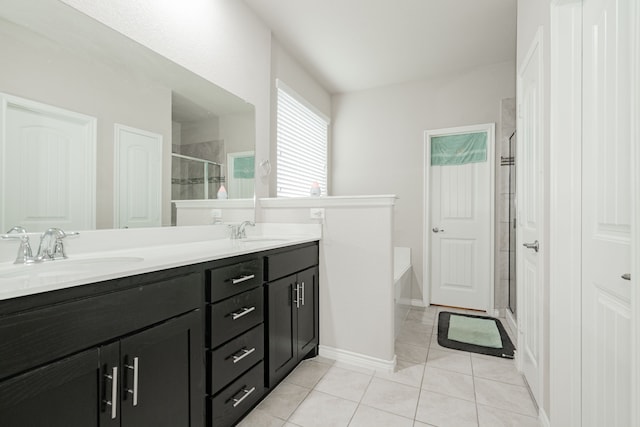 bathroom with tile patterned floors, vanity, and separate shower and tub