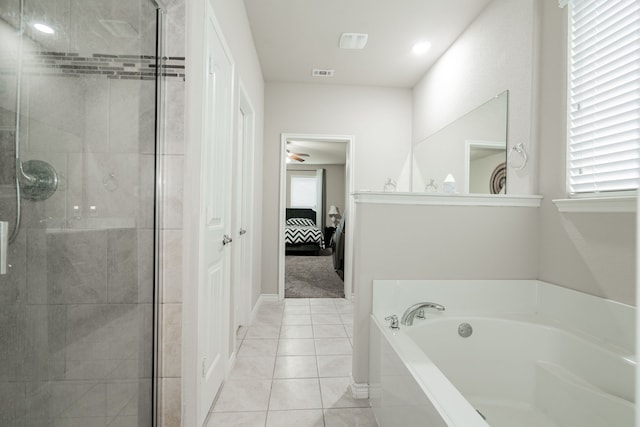 bathroom with tile patterned floors and independent shower and bath