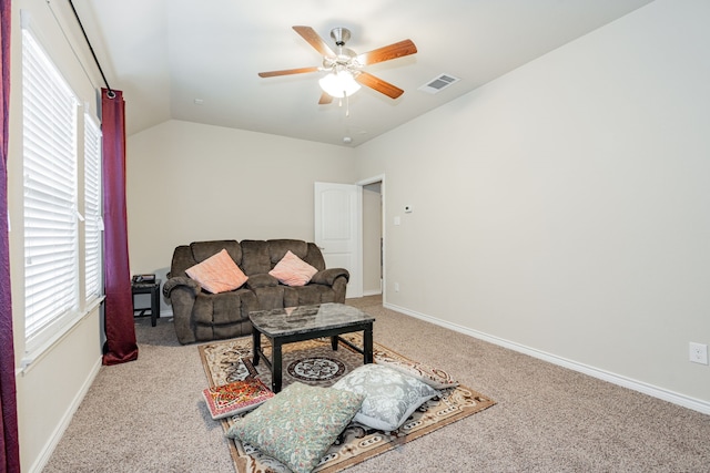 carpeted living room featuring ceiling fan, a healthy amount of sunlight, and vaulted ceiling