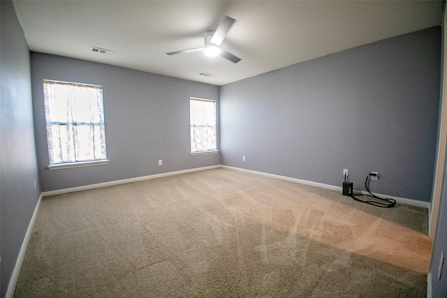 empty room with ceiling fan and carpet floors