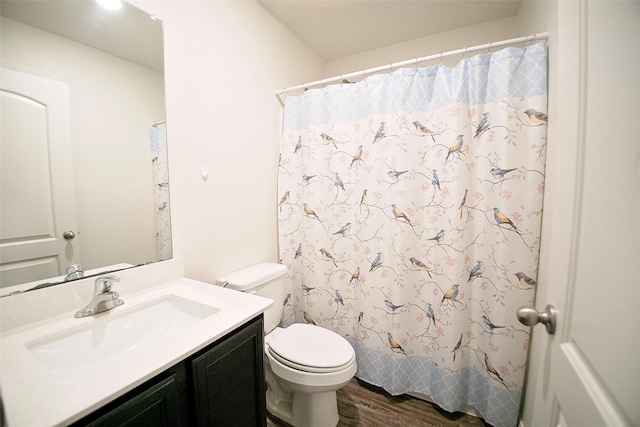 bathroom featuring a shower with curtain, toilet, vanity, and hardwood / wood-style flooring