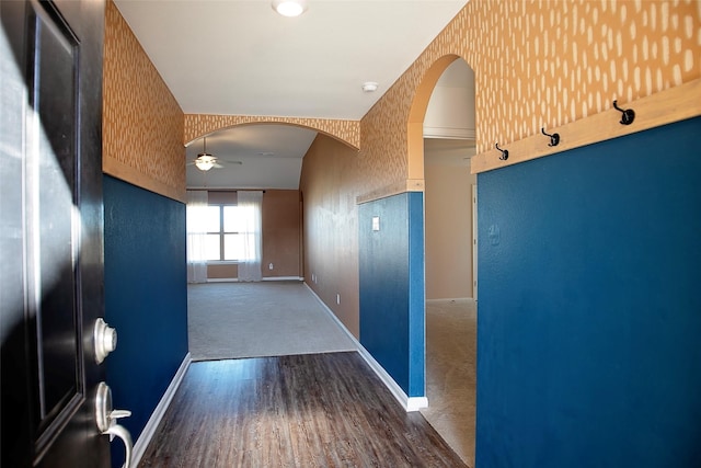 hall featuring dark hardwood / wood-style floors and lofted ceiling