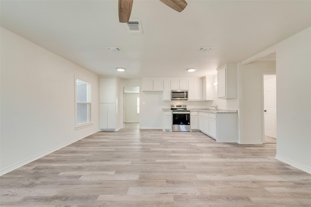 unfurnished living room with ceiling fan, light hardwood / wood-style floors, and sink