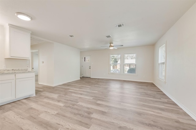 unfurnished living room with ceiling fan and light hardwood / wood-style flooring