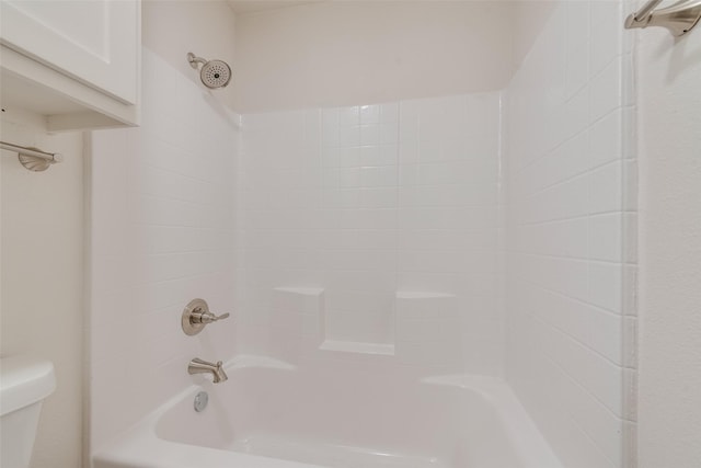 bathroom featuring shower / tub combination and toilet