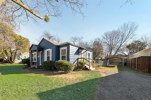 view of home's exterior featuring a lawn and a carport