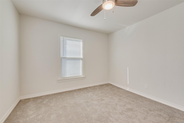 empty room featuring ceiling fan and light colored carpet