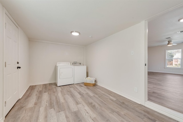 washroom with light wood-type flooring, ceiling fan, and washing machine and clothes dryer