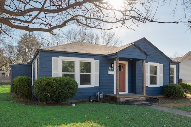 bungalow-style house with a front yard