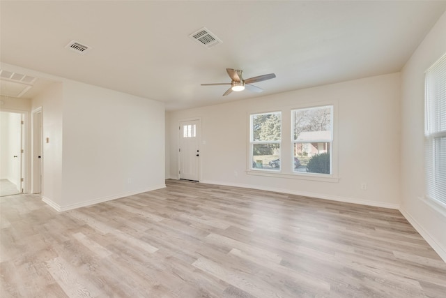 empty room featuring ceiling fan and light hardwood / wood-style floors