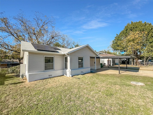 back of house with a yard and a carport