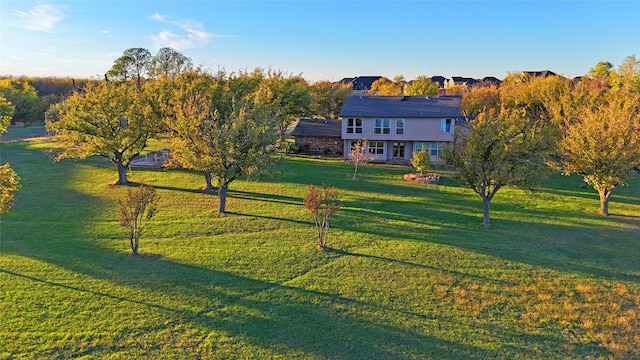 view of front of house with a rural view and a front yard