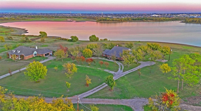 aerial view at dusk with a water view