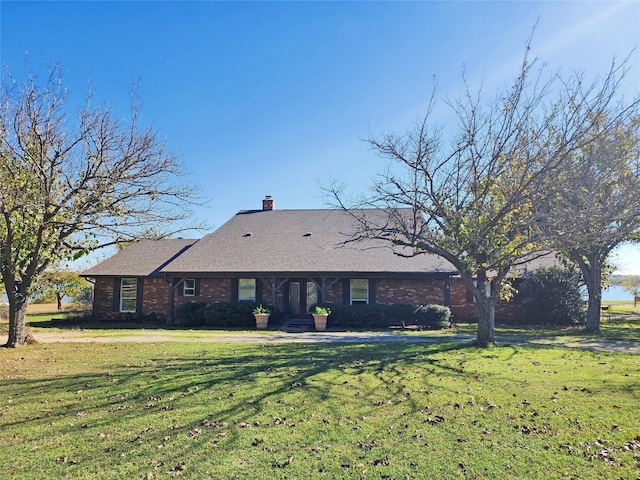 back of property featuring a lawn