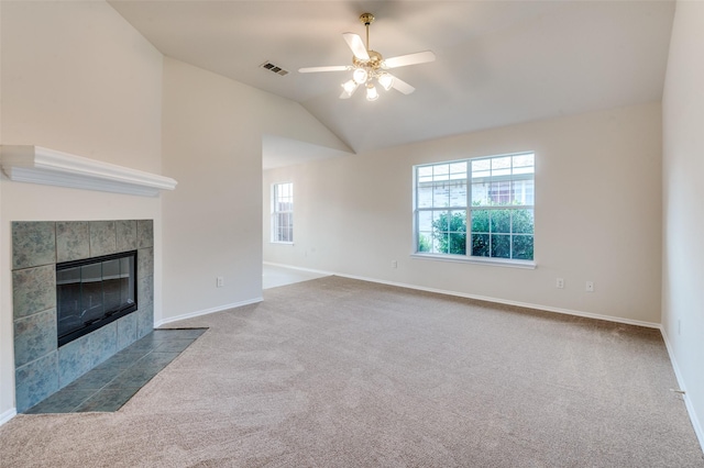 unfurnished living room with carpet flooring, a fireplace, a healthy amount of sunlight, and lofted ceiling