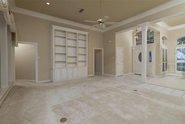 unfurnished living room featuring ceiling fan, light colored carpet, ornamental molding, and a high ceiling