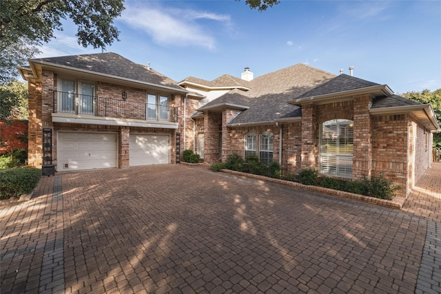 view of front of home with a balcony and a garage