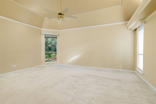 carpeted empty room featuring ceiling fan, crown molding, and vaulted ceiling