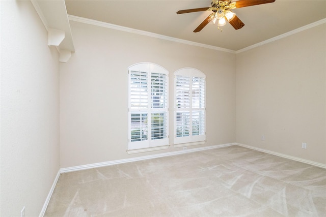 carpeted spare room with ornamental molding and ceiling fan