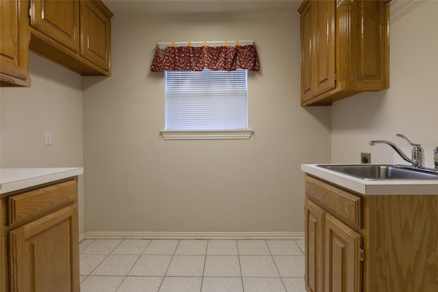 kitchen with light tile patterned flooring and sink