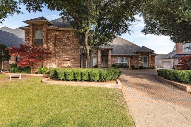 view of front facade with a garage and a front lawn