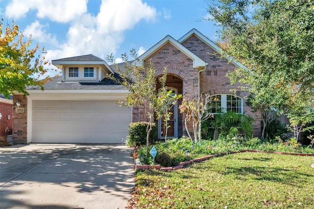 view of front of property with a garage and a front lawn