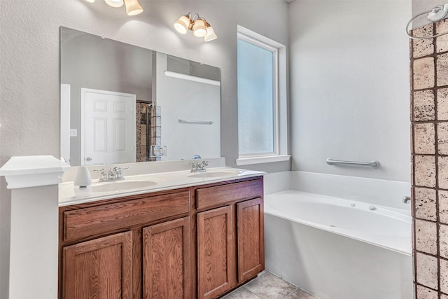 bathroom featuring a bathing tub, vanity, and tile patterned floors