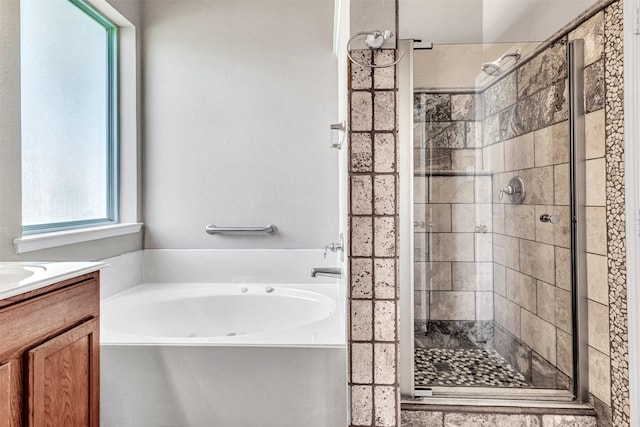 bathroom featuring shower with separate bathtub and vanity