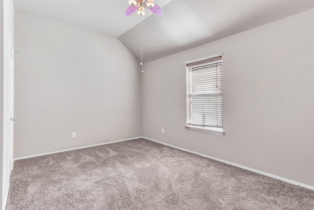 carpeted spare room featuring ceiling fan and vaulted ceiling