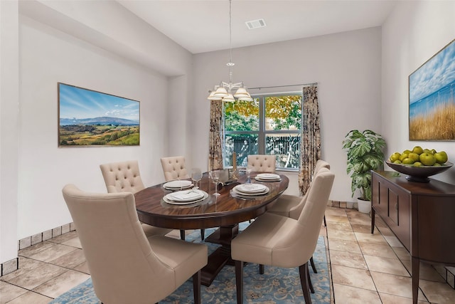 dining space featuring light tile patterned flooring and a notable chandelier