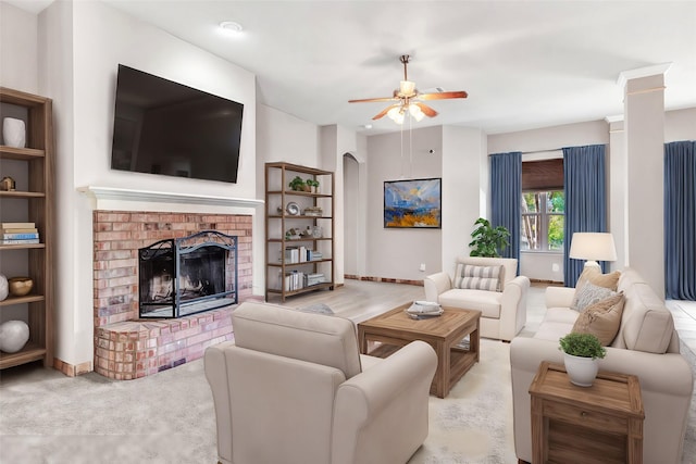 living room with ceiling fan, light carpet, and a fireplace